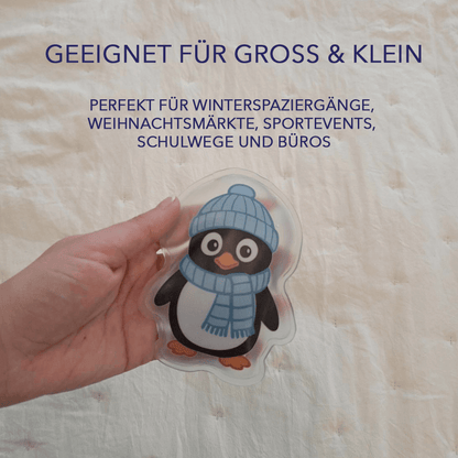 Hand hält Pinguin-Taschenwärmer; Text im Bild: „Geeignet für groß & klein … Winterspaziergänge, Weihnachtsmärkte, Sportevents, Schulwege und Büros“ – Aussage: vielseitig nutzbar.