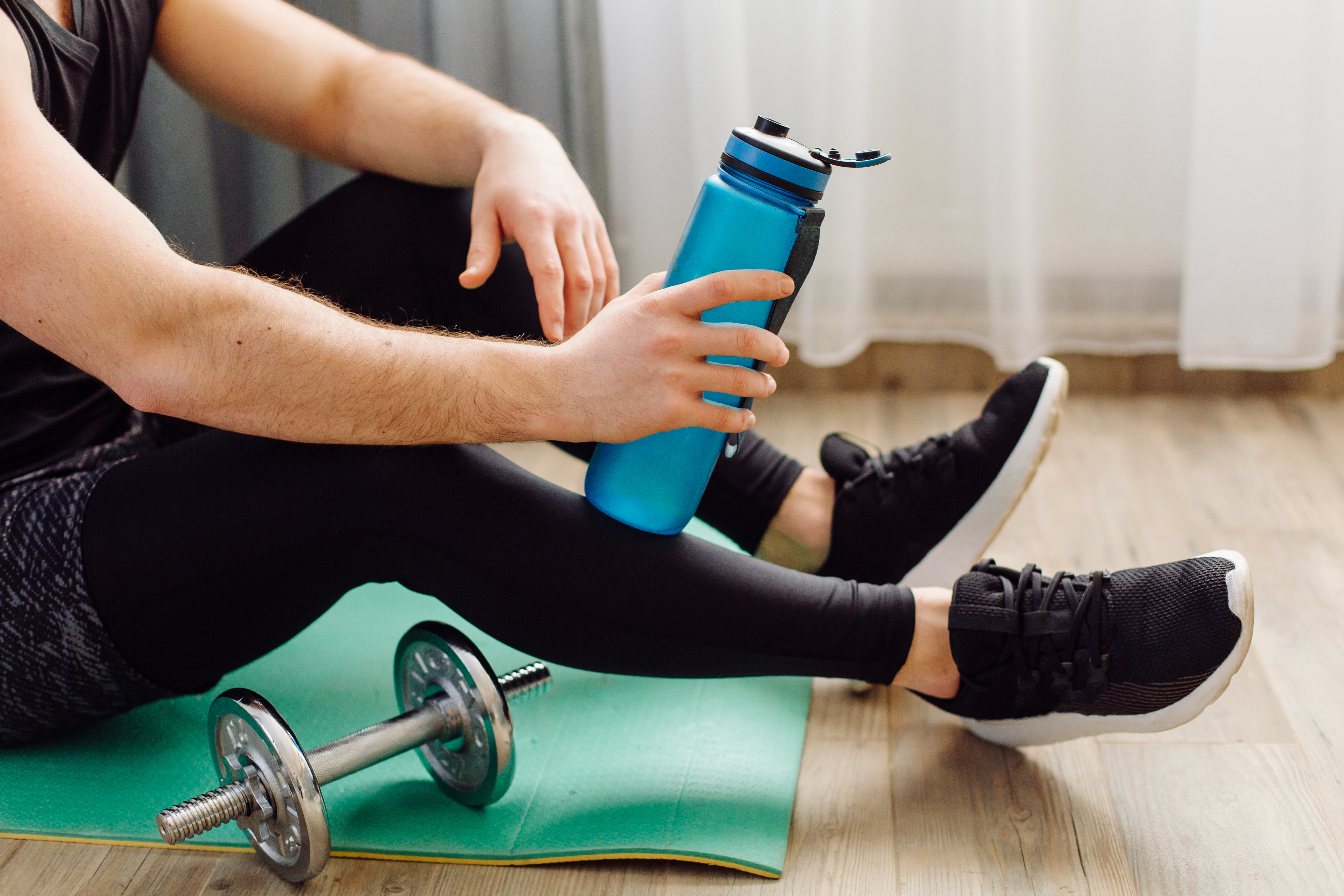 young-man-making-sport-exercises-home